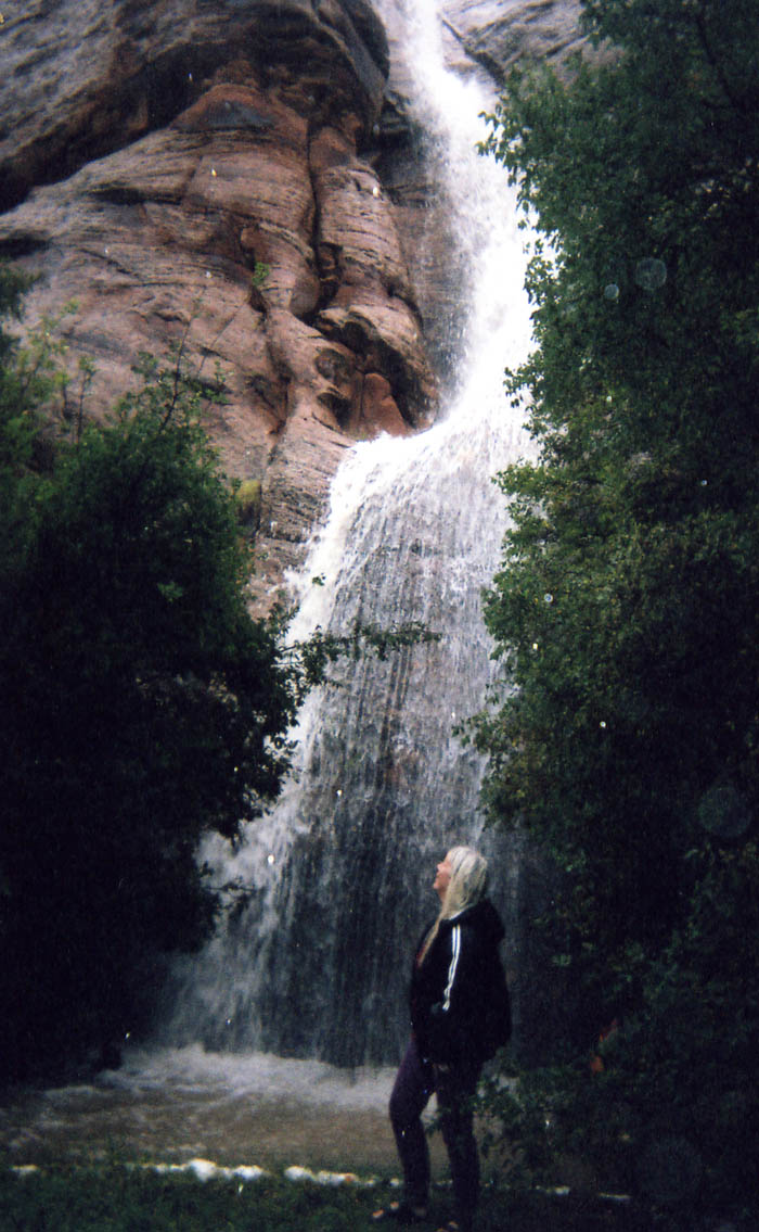 Roberta standing under a waterfall